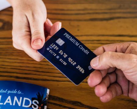 two hands changing credit card